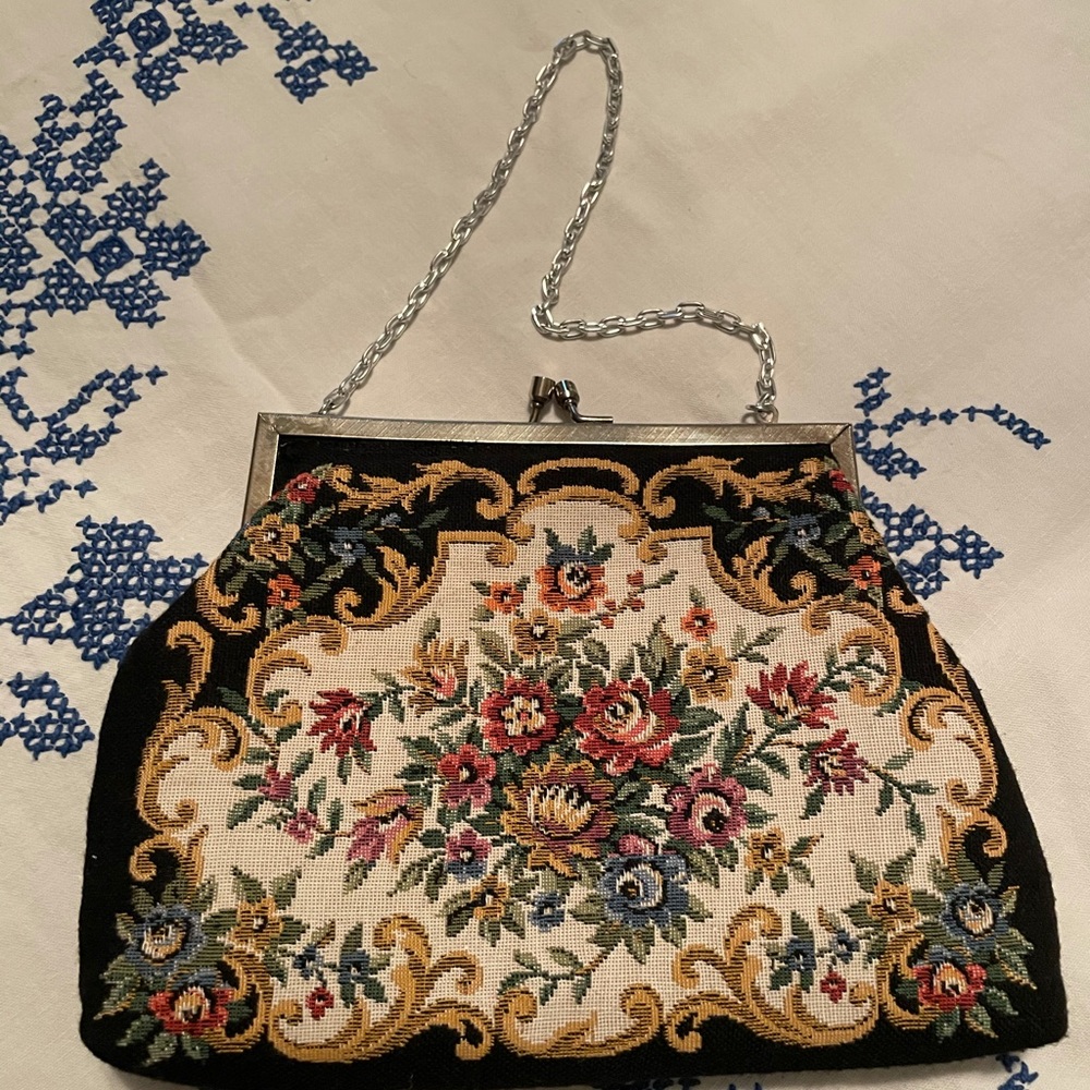 Needle point purse with silver chain handle.